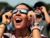 Tessa Carreiro, is wowed by what she sees as she and others gather in front of the UMass Dartmouth observatory to view the partial solar eclipse that swept over the area.   [ PETER PEREIRA/THE STANDARD-TIMES/SCMG ]